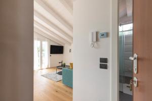 an open door to a living room with a ceiling at Olmo Suites in Como