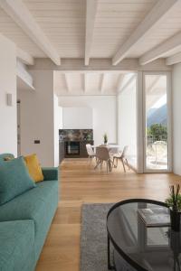 a living room with a green couch and a table at Olmo Suites in Como