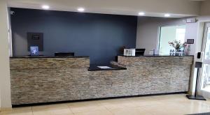 a lobby with a counter with a brick wall at Best Western Louisville South - Shepherdsville in Shepherdsville