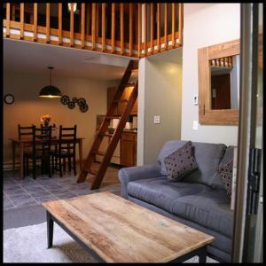 a living room with a couch and a loft bed at LOGE Alta Crystal Resort at Mt Rainier in Enumclaw