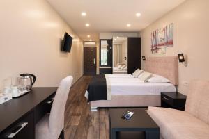 a hotel room with a bed and a couch at Hotel Central Beach 9 in Makarska