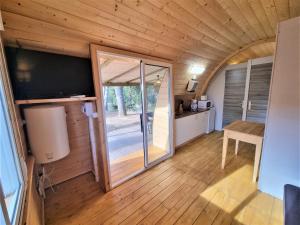 a kitchen and living room in a tiny house at Bungalow Nomad Harmonia in L'Escala