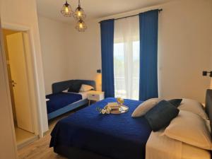 a bedroom with a blue bed with a tray of food on it at Apartment Ana - Gradac in Gradac
