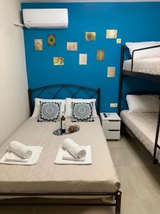 a room with a bed with a blue wall at Sweet Maison Apartment in Paralia Katerinis