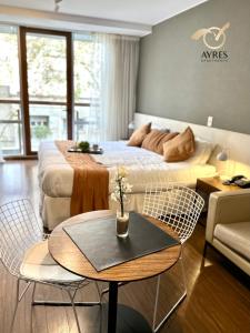 1 dormitorio con 1 cama, mesa y sillas en Ayres Apartments Palermo en Buenos Aires