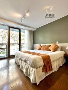 a bedroom with a large bed and a large window at Ayres Apartments Palermo in Buenos Aires