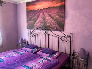 a bedroom with a bed with a painting on the wall at Pentz House in Siófok +41 photos