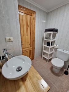 a bathroom with a white sink and a toilet at Apartamento CA VALEN 1 in Peniscola +5 photos
