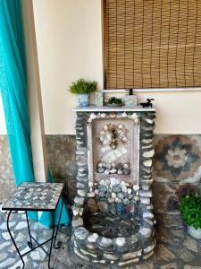 a stone fireplace in a room with a window at Holiday Oasis with private patio and Hammam-style bath in Chora-Pithagoreo, Samos Island in Chóra