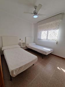 a hospital room with two beds and a window at Apartamento CA VALEN 1 in Peñíscola