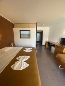 a hotel room with a bed with towels on it at Juiceven Studios in Alcabideche