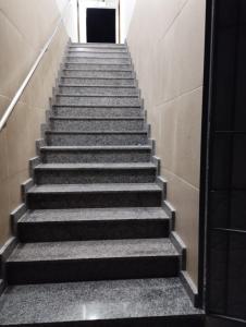 a stairway leading up to a door in a building at Residencial Casa Grande - Apto 03 in Santa Cruz Cabrália