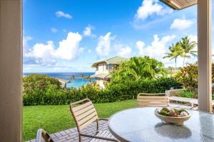 a patio with a table and chairs and the ocean at K B M Resorts Kapalua Bay Villas KBV 17G4 bed Ocean Front in Kapalua