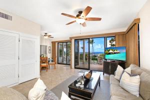 a living room with a couch and a ceiling fan at K B M Resorts Kapalua Bay Villas KBV 17G4 bed Ocean Front in Kapalua