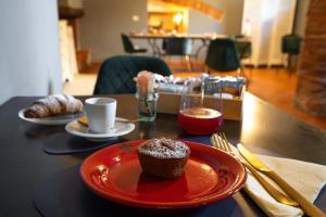 a cupcake on a red plate on a table at La Sosta in Toscana in Camaiore