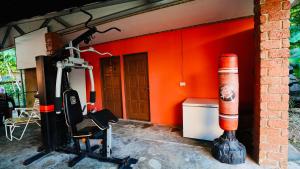 an orange wall with an orange object next to a building at HUAQIAO HOME 侨之家免费供早餐free breakfast served in Semporna