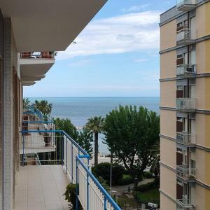 a view of the ocean from a balcony of a building at Ciccimè Sea House in Bari