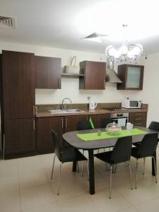 a kitchen with a table and chairs and a sink at Dead Sea Jordan Sea View Samarah Resort Traveler Award 2024 winner in Sowayma