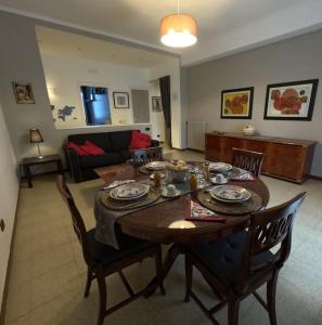 a living room with a wooden table and chairs at Ciccimè Sea House in Bari