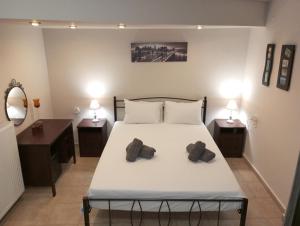 a bedroom with a bed with two towels on it at City Nikis Apartment in Volos