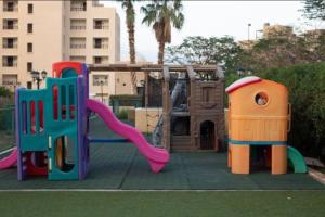 a playground with a slide and a play house at Dead Sea Jordan Sea View Samarah Resort Traveler Award 2024 winner in Sowayma