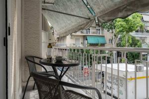 a patio with a table and chairs on a balcony at Urban Casa in Athens