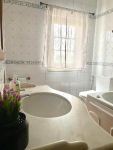 a bathroom with a tub and a sink and a toilet at Casa da Pedra Guest House in Torres Vedras