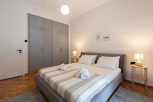 a bedroom with a large bed with two towels on it at Urban Casa in Athens