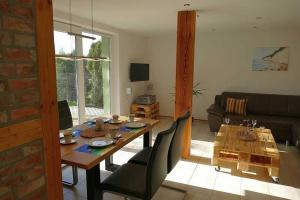 a living room with a wooden table and a dining room at Ruegen_Fewo 279_2 in Kasnevitz