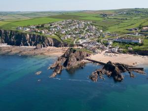 an aerial view of a beach with rocks in the water at Thornlea View in Hope-Cove