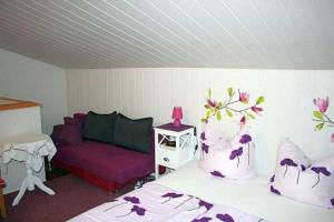 a living room with a bed and a couch at Ruegen_Fewo 241 in Putbus +49 photos