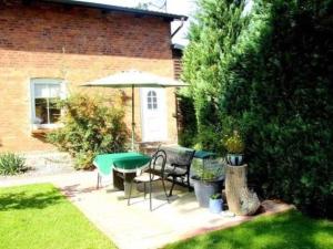 a patio with a table and chairs and an umbrella at Ruegen_Fewo 241 in Putbus