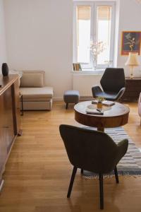 a living room with a coffee table and a chair at Apartment Laizor in Staszów