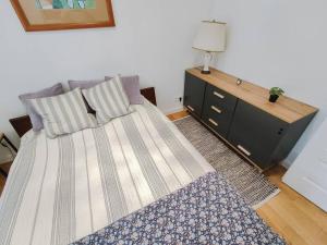 a bedroom with a bed and a dresser at Apartment Laizor in Staszów