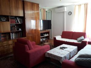 a living room with two chairs and a couch and a table at Apartment Melita in Dubrovnik