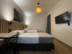 TV a/nebo společenská místnost v ubytování Vita Hotel Boutique