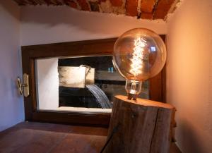 a light bulb sitting on top of a wooden block at La Sosta in Toscana in Camaiore