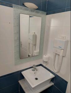 a bathroom with a sink and a mirror at Thealos in Azolimnos Syros