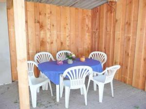 a blue table and white chairs on a patio at Ruegen_Fewo 102 in Sagard