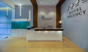 a hotel lobby with a reception desk and a hotelagency sign at Treebo Trend Regency - Bund Garden, Dhole Patil Road in Pune