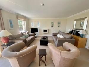 a large living room with couches and chairs at Golf Court View, Elie in Elie