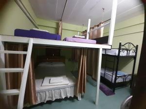 a small room with two bunk beds in it at My Travel Homestay in Haad Rin