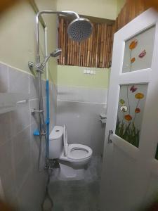 a bathroom with a toilet and a shower in it at My Travel Homestay in Haad Rin