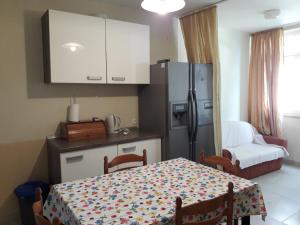 a kitchen with a table and a refrigerator at Apartment Melita in Dubrovnik