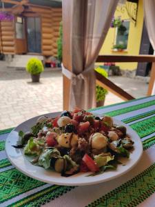 a plate of food sitting on a table at Chudodievo in Chynadievo Mini-Hotel in Chynadiyovo