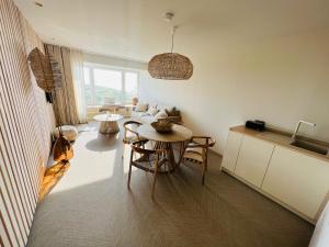 BONK suites في ميدل كيرك: مطبخ وغرفة معيشة مع طاولة وأريكة