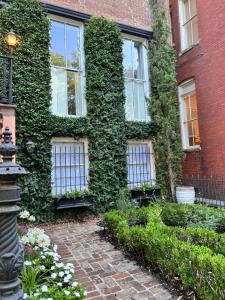 a building covered in green ivy with a walkway at Be Our Gaston's A Walk in the Park in Savannah