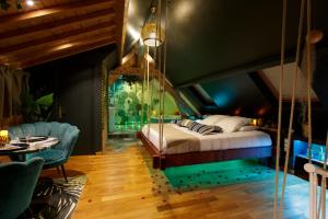 a bedroom with a swing bed and a table at Sweety Loft Suites romantique avec jacuzzi in Friville-Escarbotin