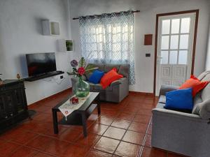 a living room with two couches and a coffee table at Casa La Era in El Paso