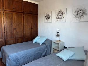 a bedroom with two beds and a cabinet at Casa La Era in El Paso